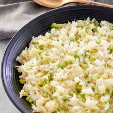 sauerkraut salad in a bowl and a spoon next to it.