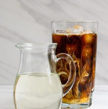 copycat Starbucks classic syrup in a small pitcher next to iced coffee.