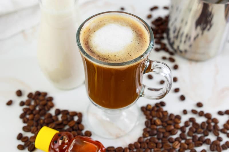 homemade Starbucks honey almond milk flat white, coffee beans, and honey