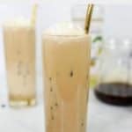 homemade Starbucks iced vanilla latte with a straw.