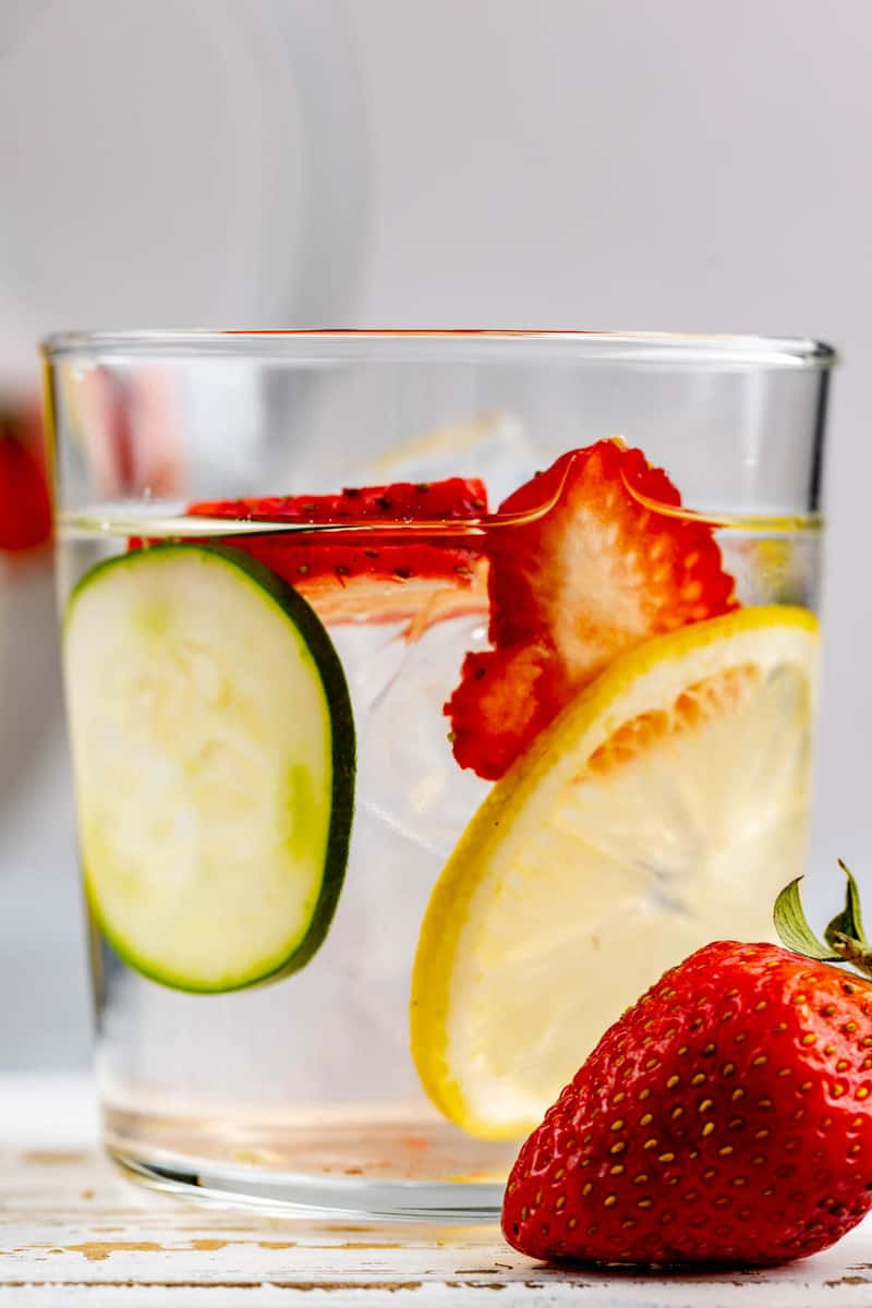 a glass of strawberry lemon cucumber water with fresh fruit.
