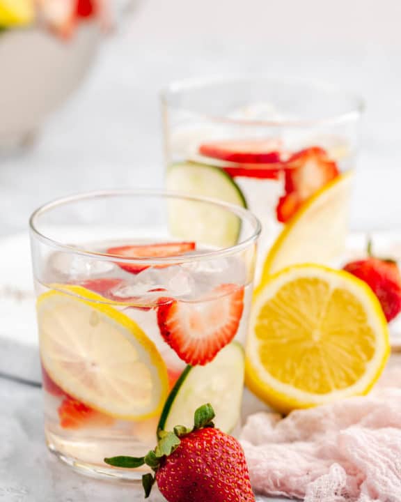 strawberry lemon cucumber water in glasses and fresh fruit.