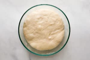 Texas Roadhouse rolls dough in a bowl.