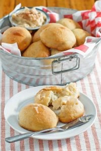 copycat Texas Roadhouse rolls in a metal tub and on a plate.