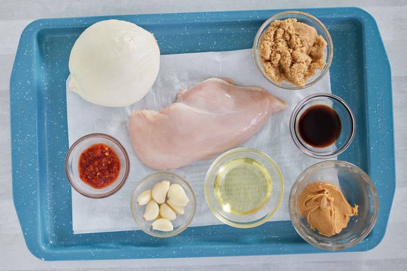 Thai peanut chicken ingredients on a tray.