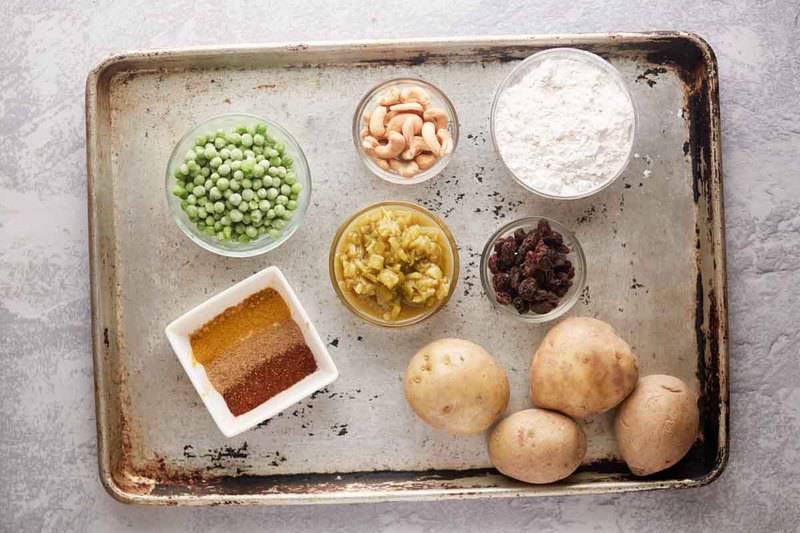 vegetable samosa ingredients on a baking sheet.