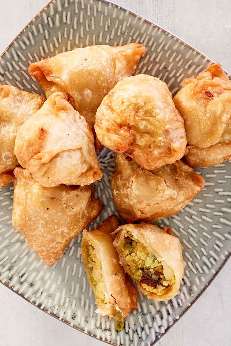 overhead view of vegetable samosas on a platter.