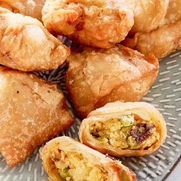 Indian vegetable samosas on a platter.