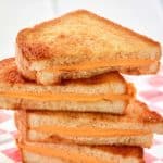 air fryer grilled cheese sandwich slices on parchment paper.