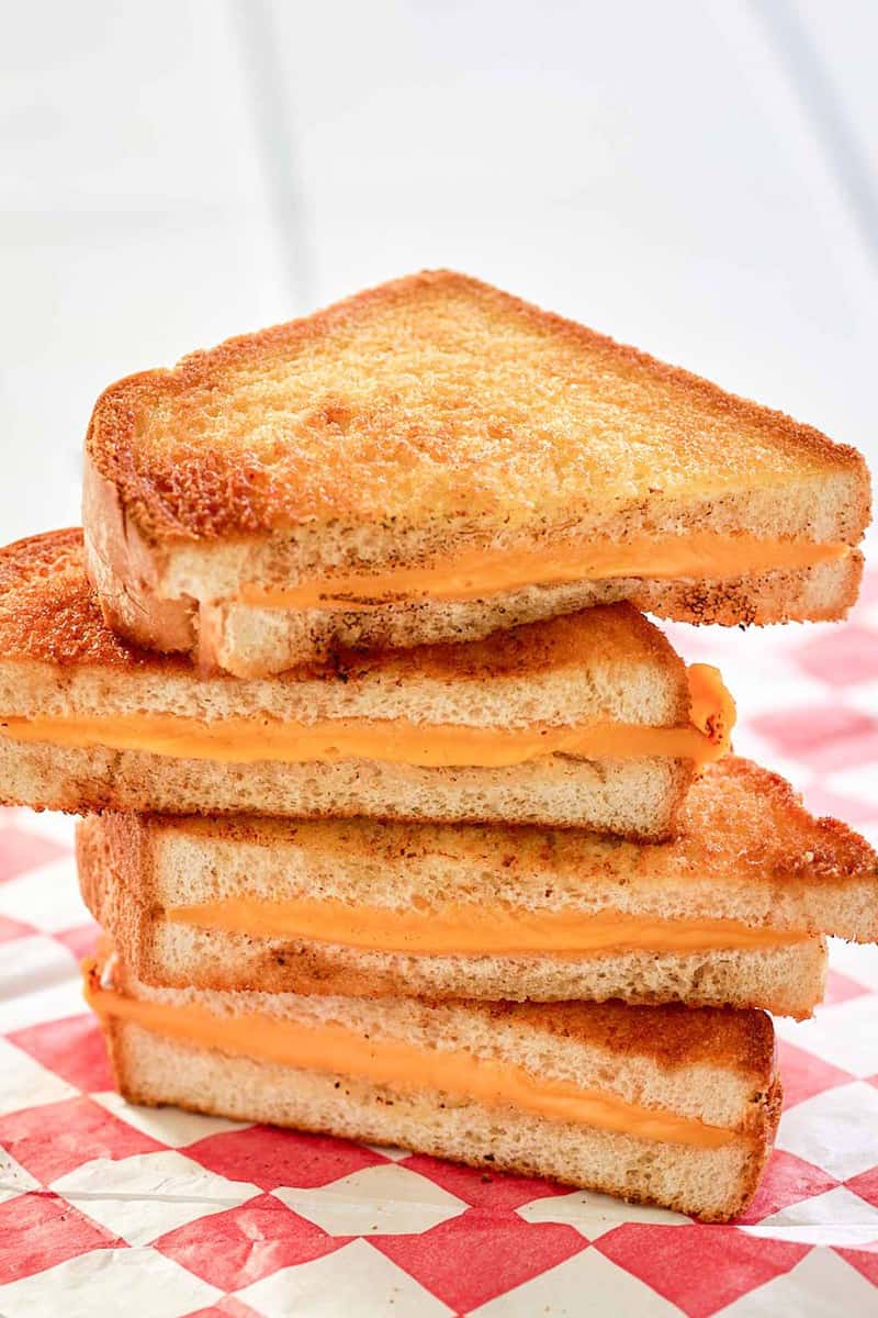 air fryer grilled cheese sandwich slices on parchment paper.