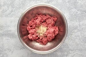 ground beef and seasonings in a mixing bowl.