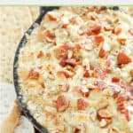 hot bacon and swiss cheese dip with chopped almonds on top.