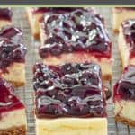 blueberry cheesecake bars on a wire rack.