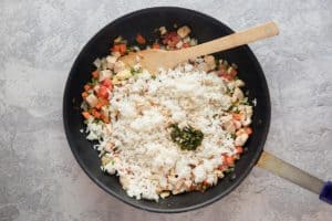 rice, chicken, and vegetables in a skillet.