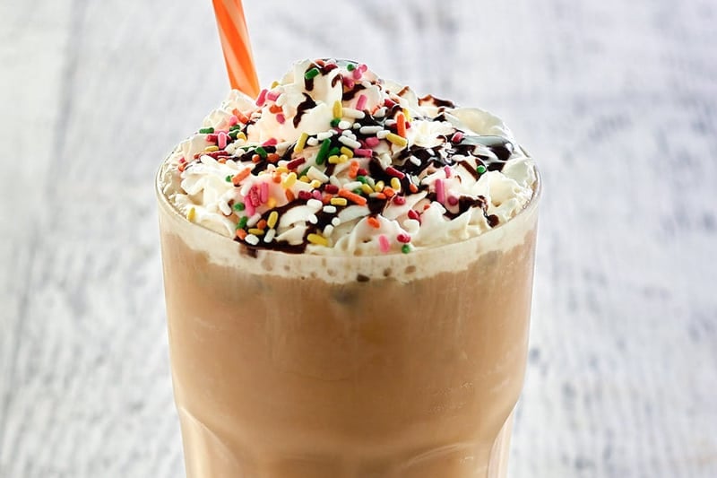 copycat Dunkin Donuts iced cake batter latte with toppings.