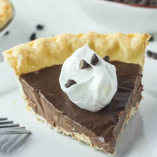homemade chocolate pie with a dollop of whipped cream on top.