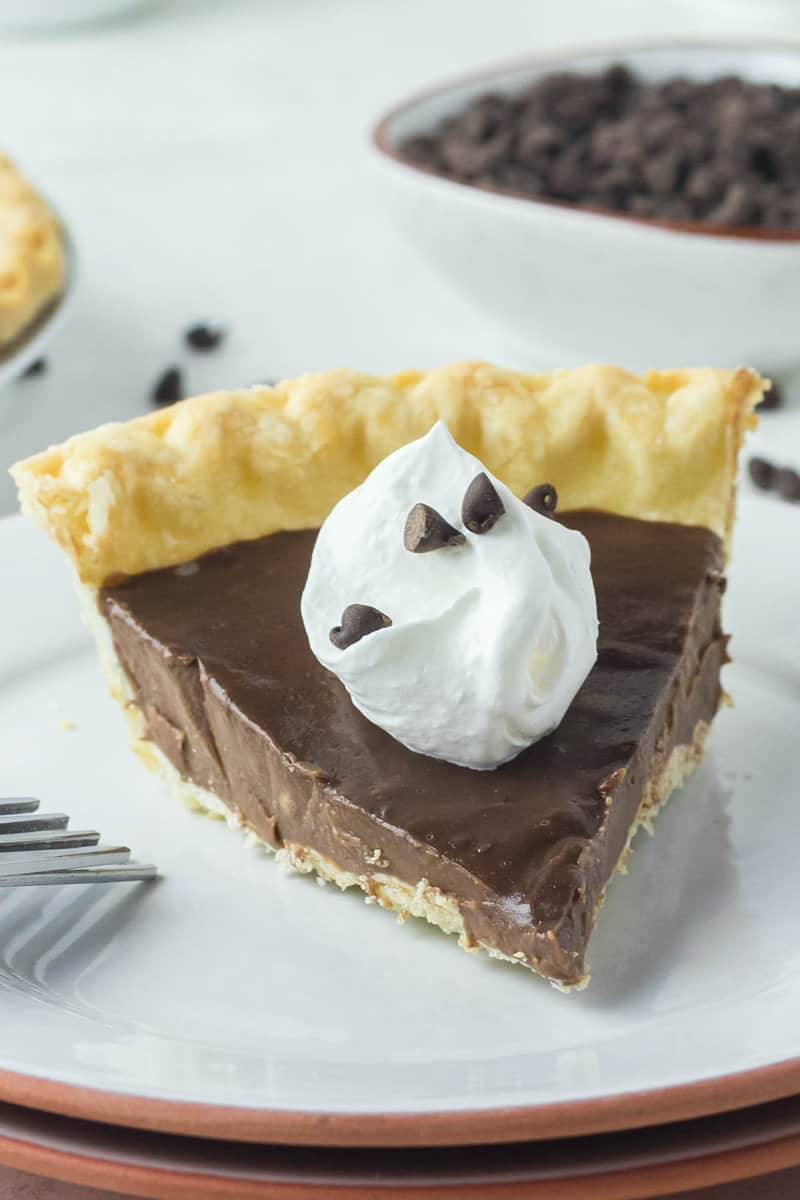 homemade chocolate pie with a dollop of whipped cream on top.