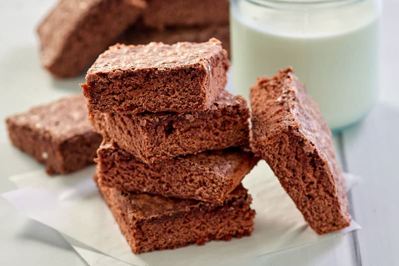 five homemade fudge brownies and a glass of milk.