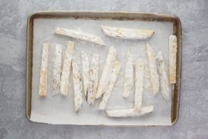 breaded potato wedges before frying.