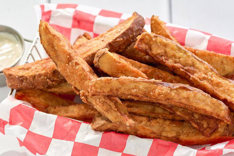 homemade seasoned potato wedges in a basket.