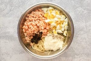 shrimp pasta salad ingredients in a mixing bowl.