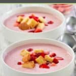 two bowls of cold strawberry soup with pound cake croutons.