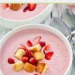 bowl of strawberry soup with pound cake croutons and strawberries.