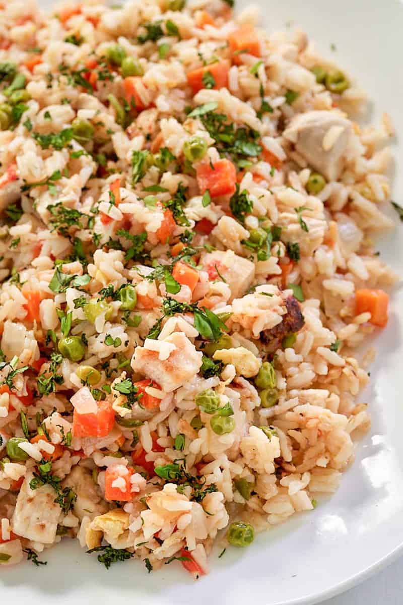 Thai chicken fried rice with vegetables on a platter.