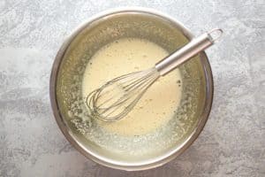 whisked eggs and sugar in a mixing bowl.