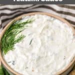 bowl of homemade Arby's tzatziki sauce garnished with fresh dill.