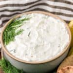 bowl of homemade Arby's tzatziki sauce and fresh dill.