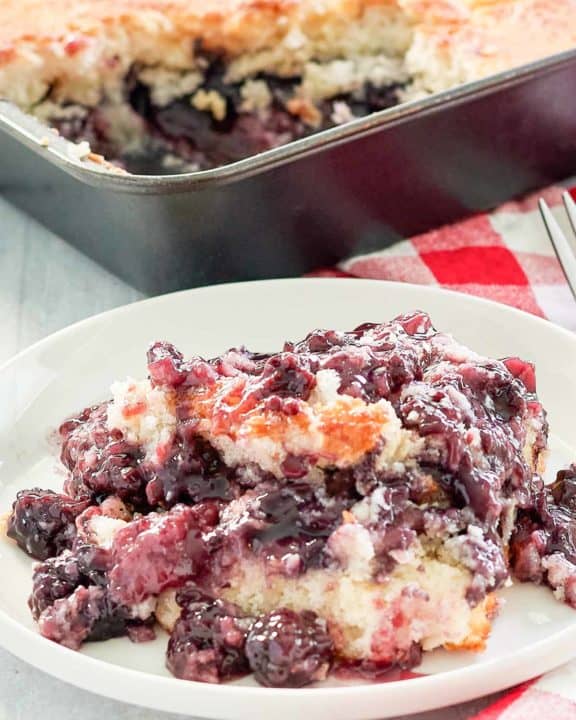 blackberry cobbler on a plate and in a baking pan.