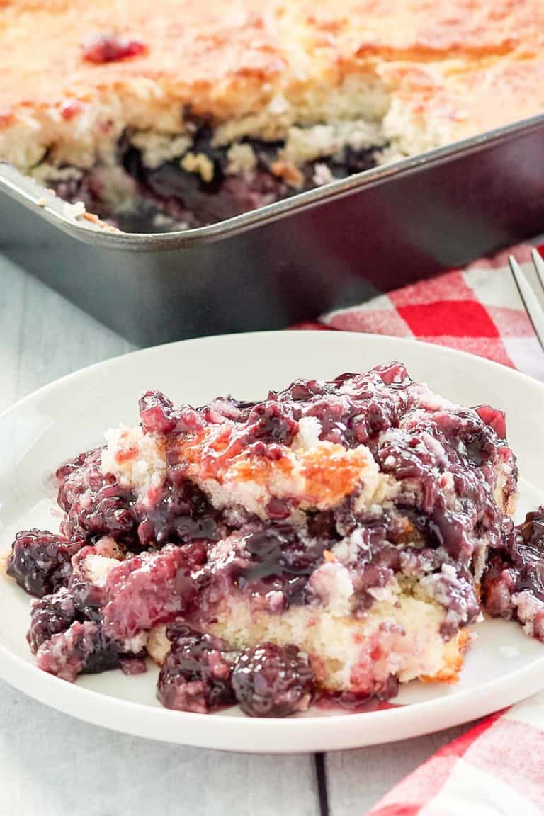 blackberry cobbler on a plate and in a baking pan.