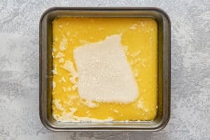 butter and cobbler batter in a baking pan.