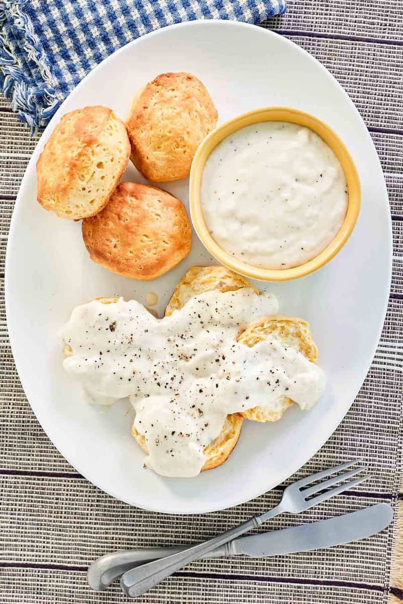 overhead view of copycat Cracker Barrel sawmill gravy and biscuits on a plate.