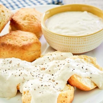 copycat Cracker Barrel sawmill gravy over biscuits and in a bowl.