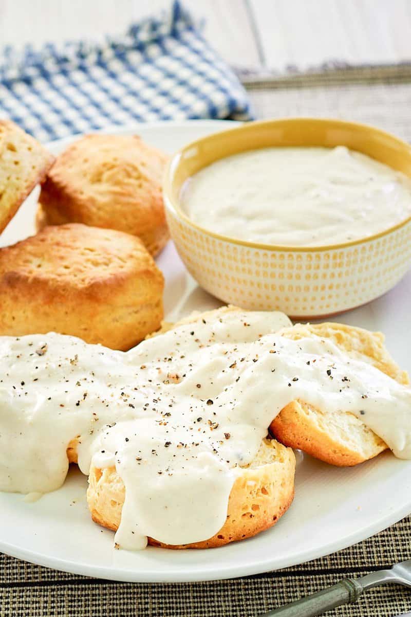 copycat Cracker Barrel sawmill gravy over biscuits and in a bowl.