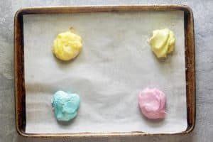 colored cream cheese mints mixture on a baking sheet.