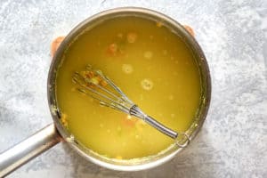 broth and vegetables in a pan.