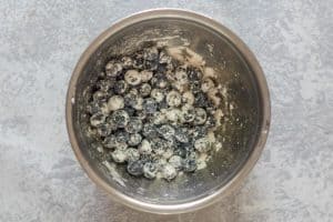 flour coated blueberries in a bowl.
