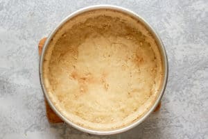 baked cheesecake crust in a pan.