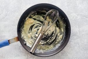 roux and a whisk in a skillet.