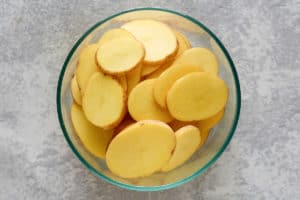 round potato slices in a bowl.