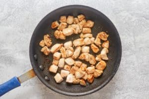 cooked chicken pieces in a skillet.