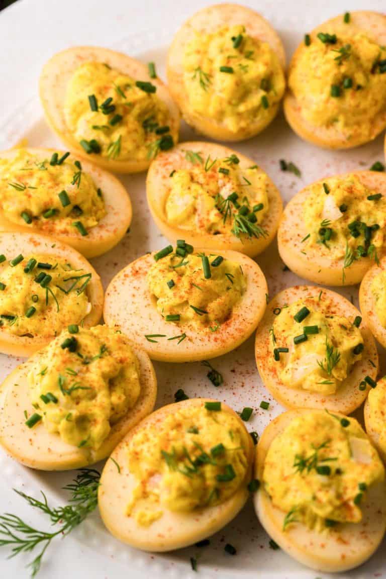smoked deviled eggs on a round white platter.