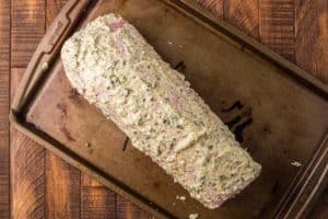 eye of round roast coated with horseradish herb rub sauce.