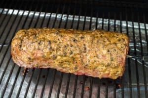 smoked eye of round roast on a smoker grate.