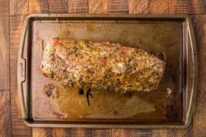 smoked eye of round roast resting on a baking sheet.