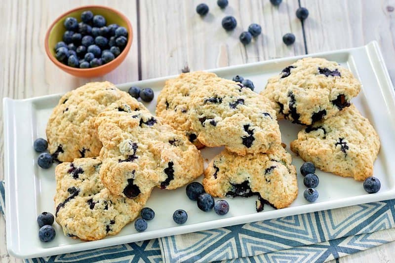 copycat Starbucks blueberry scones and a bowl of fresh blueberries.