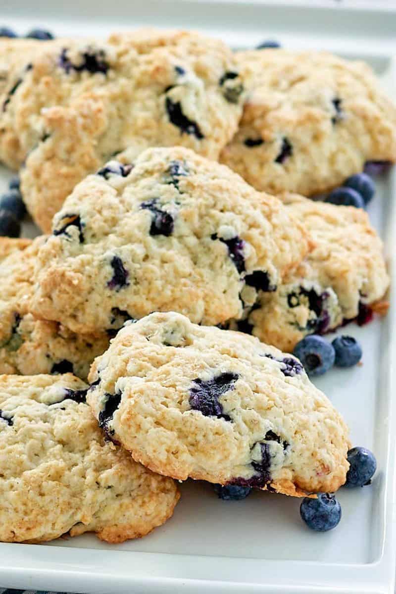 copycat Starbucks blueberry scones and blueberries on a platter.